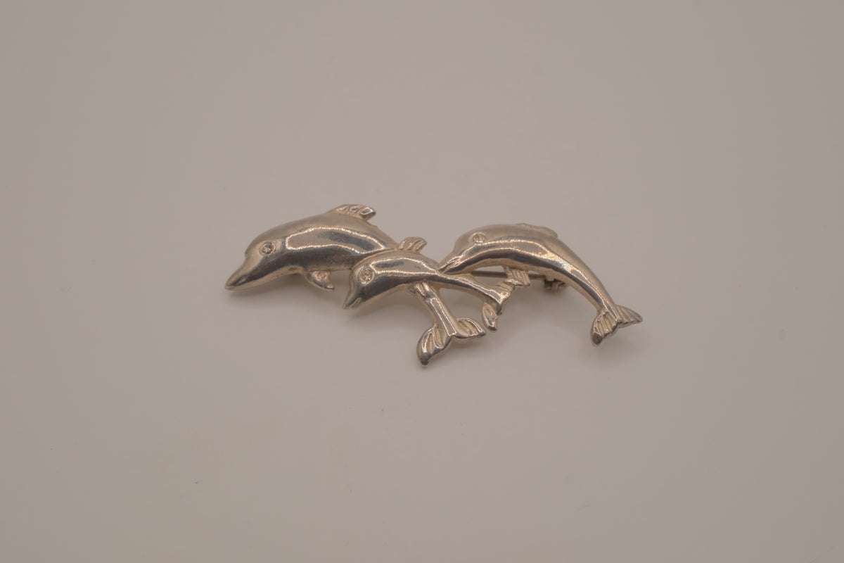 Vintage silver tone three-dolphin brooch