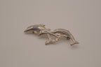Vintage silver tone three-dolphin brooch