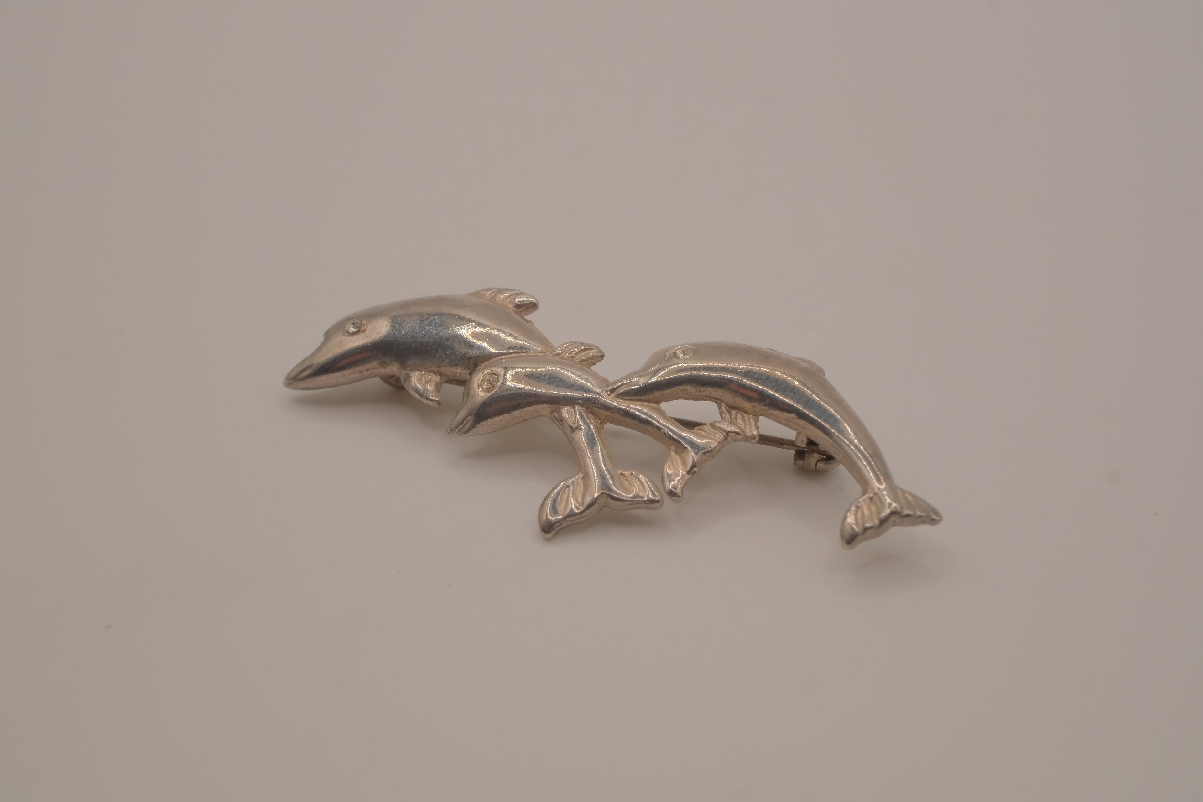 Vintage silver tone three-dolphin brooch