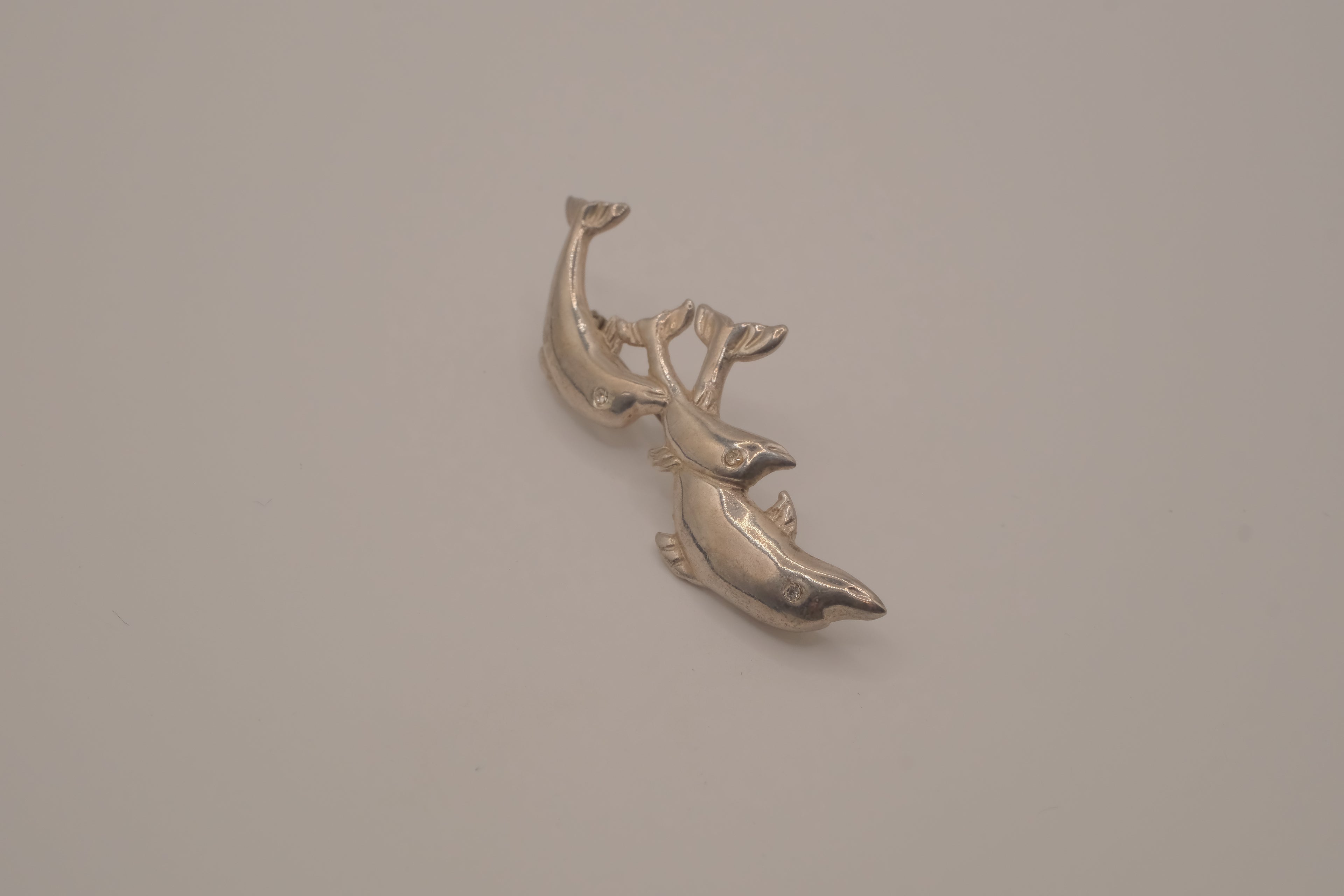 Vintage silver tone three-dolphin brooch