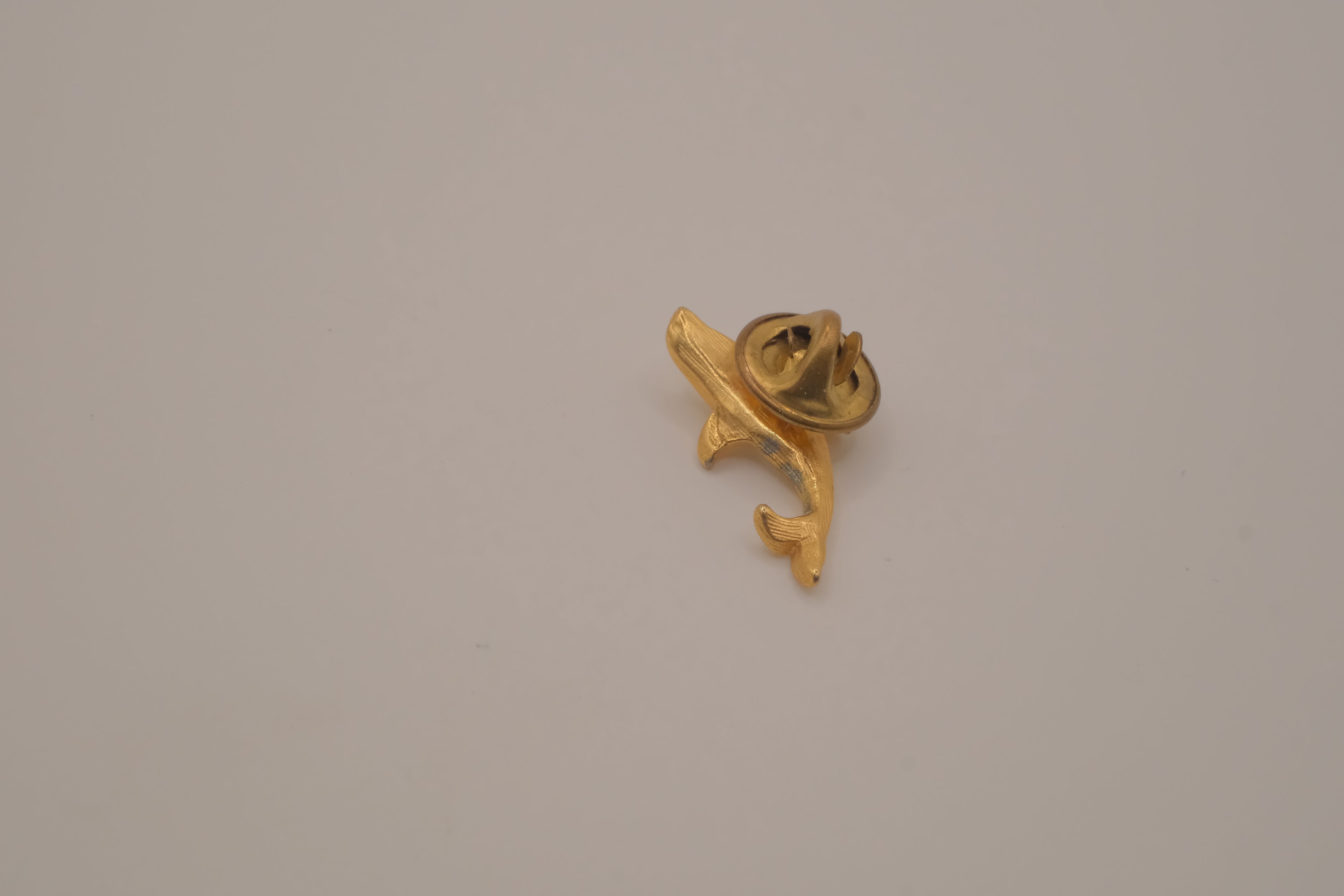 Vintage gold-toned dolphin rhinestone lapel pin