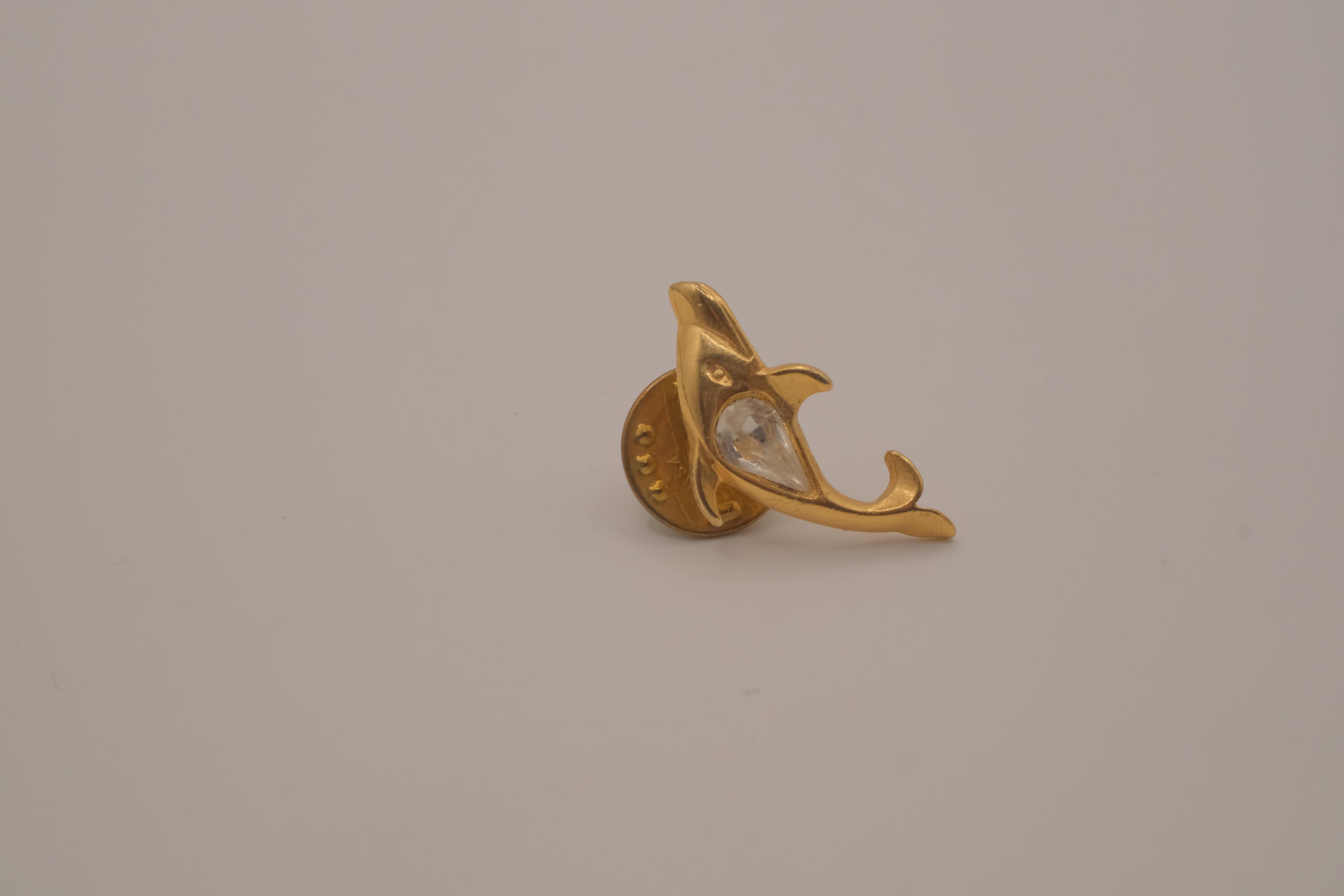 Vintage gold-toned dolphin rhinestone lapel pin
