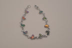 Silver-tone abalone dolphin as crescent motifs link bracelet