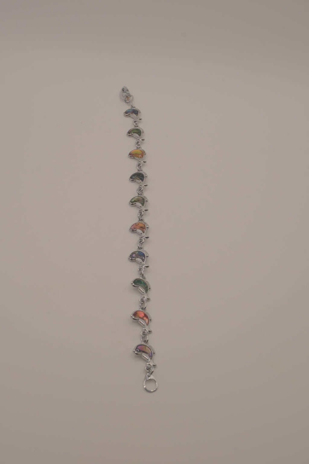 Silver-tone abalone dolphin as crescent motifs link bracelet