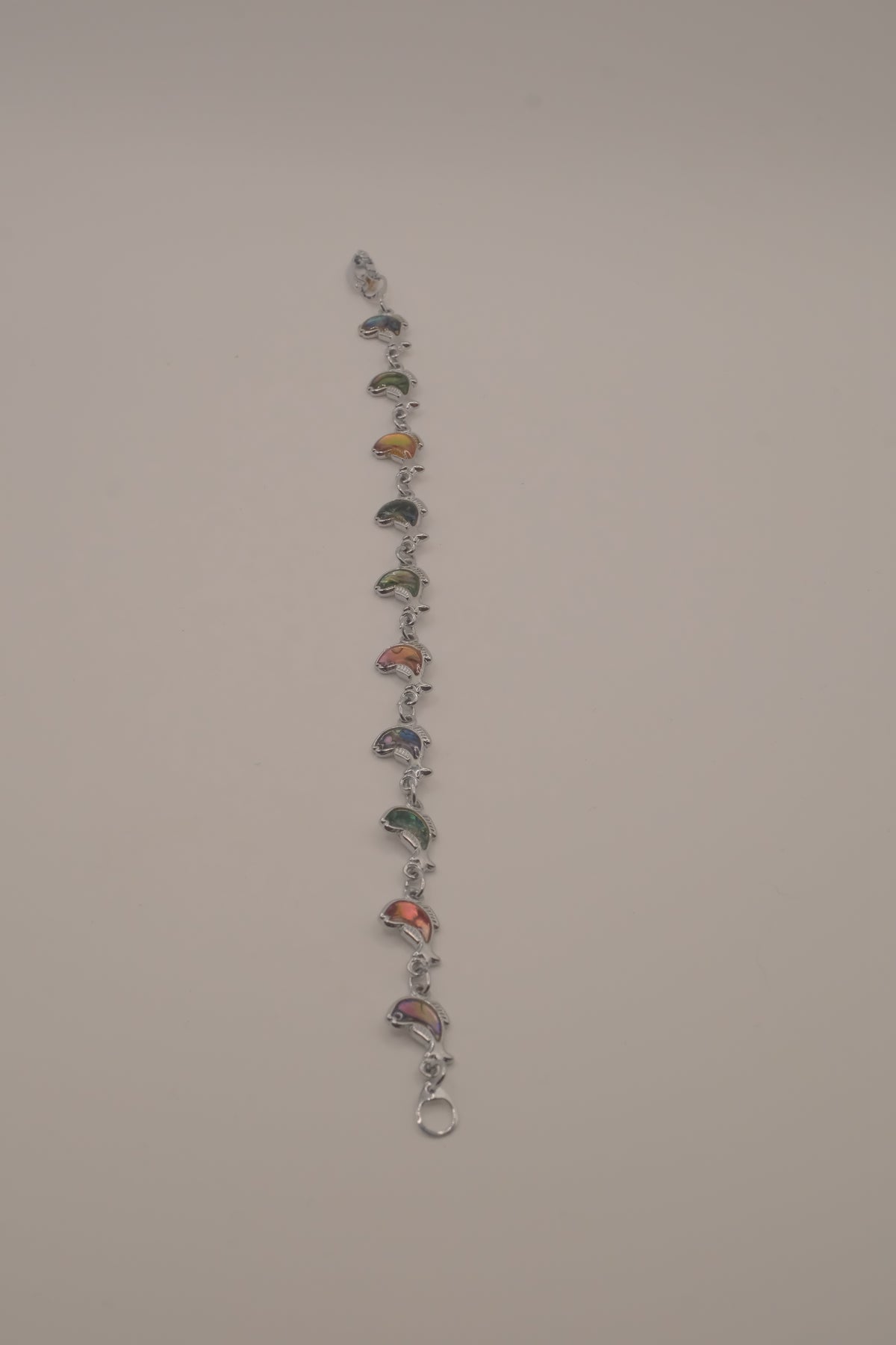 Silver-tone abalone dolphin as crescent motifs link bracelet
