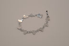 Silver-tone abalone dolphin as crescent motifs link bracelet