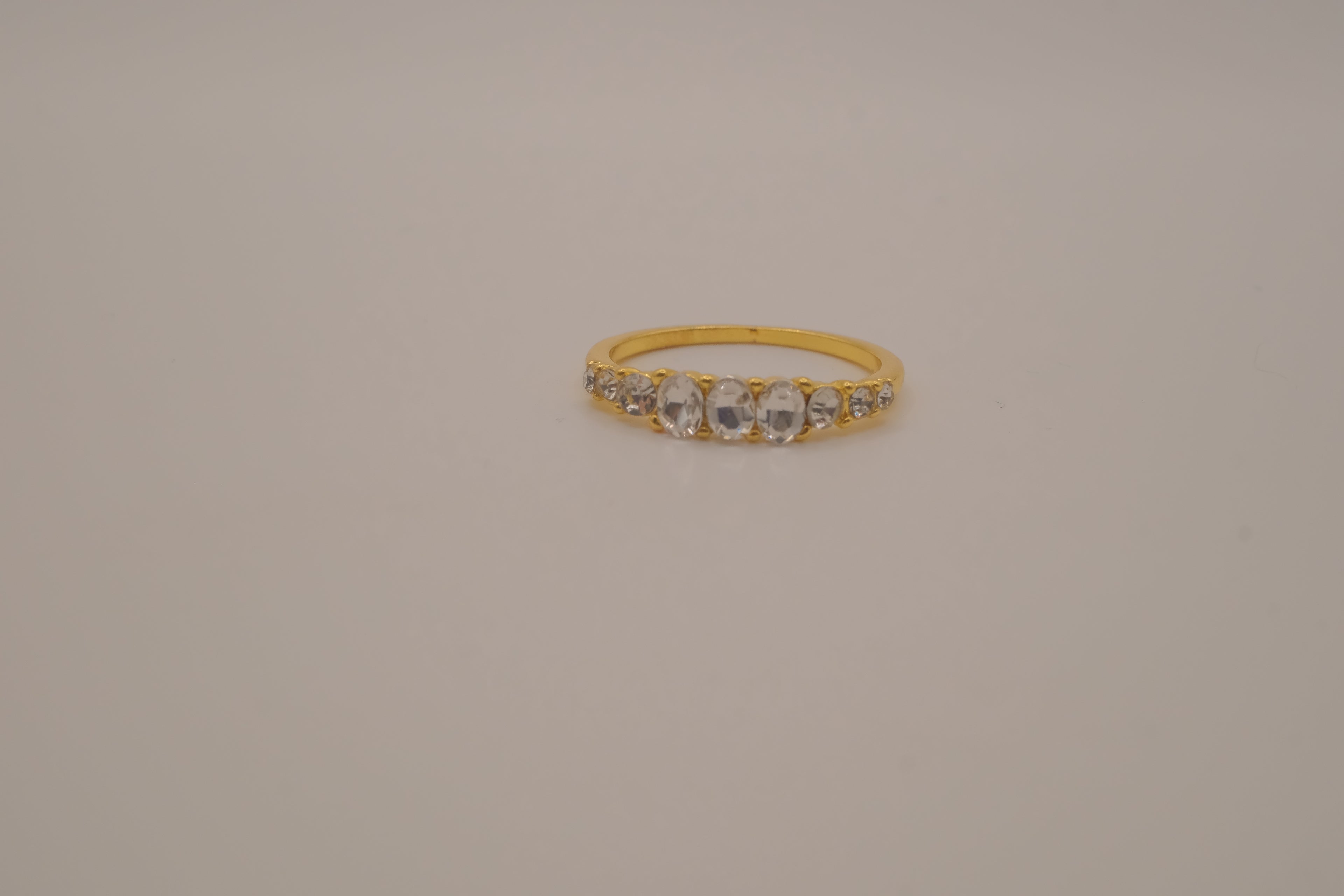Gold tone prong-set oval clear stones ring