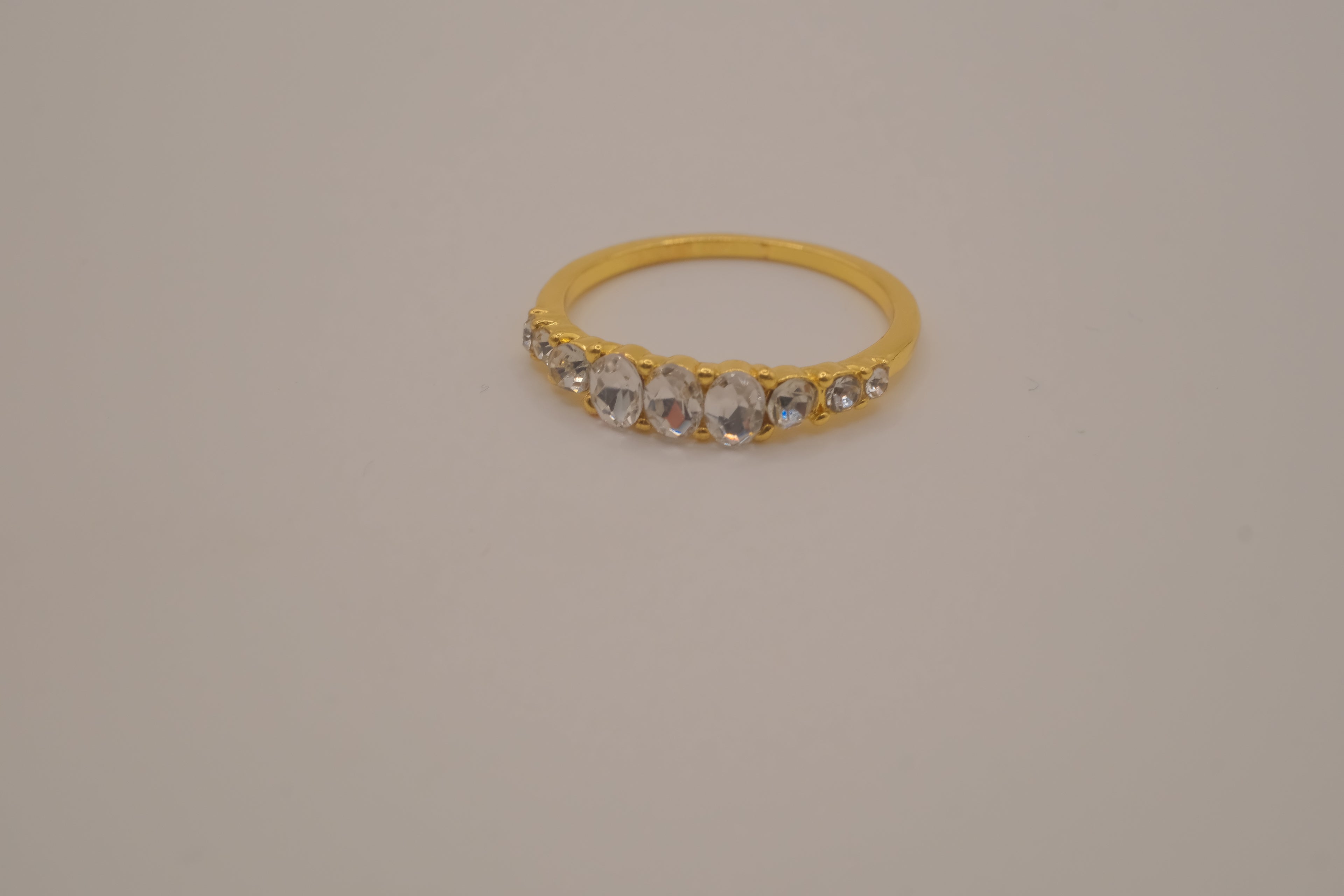 Gold tone prong-set oval clear stones ring