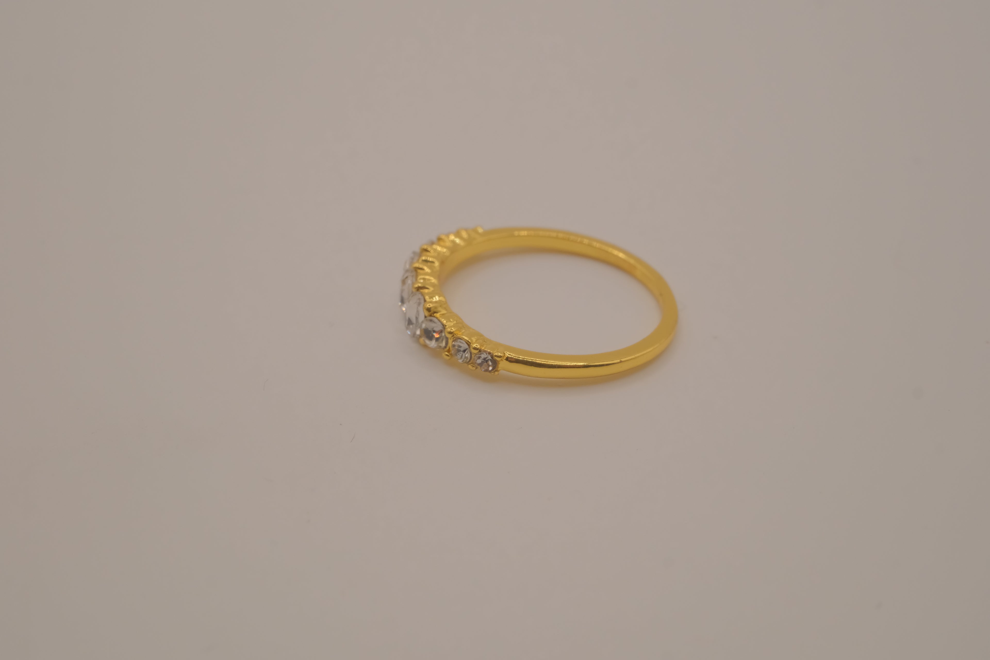 Gold tone prong-set oval clear stones ring