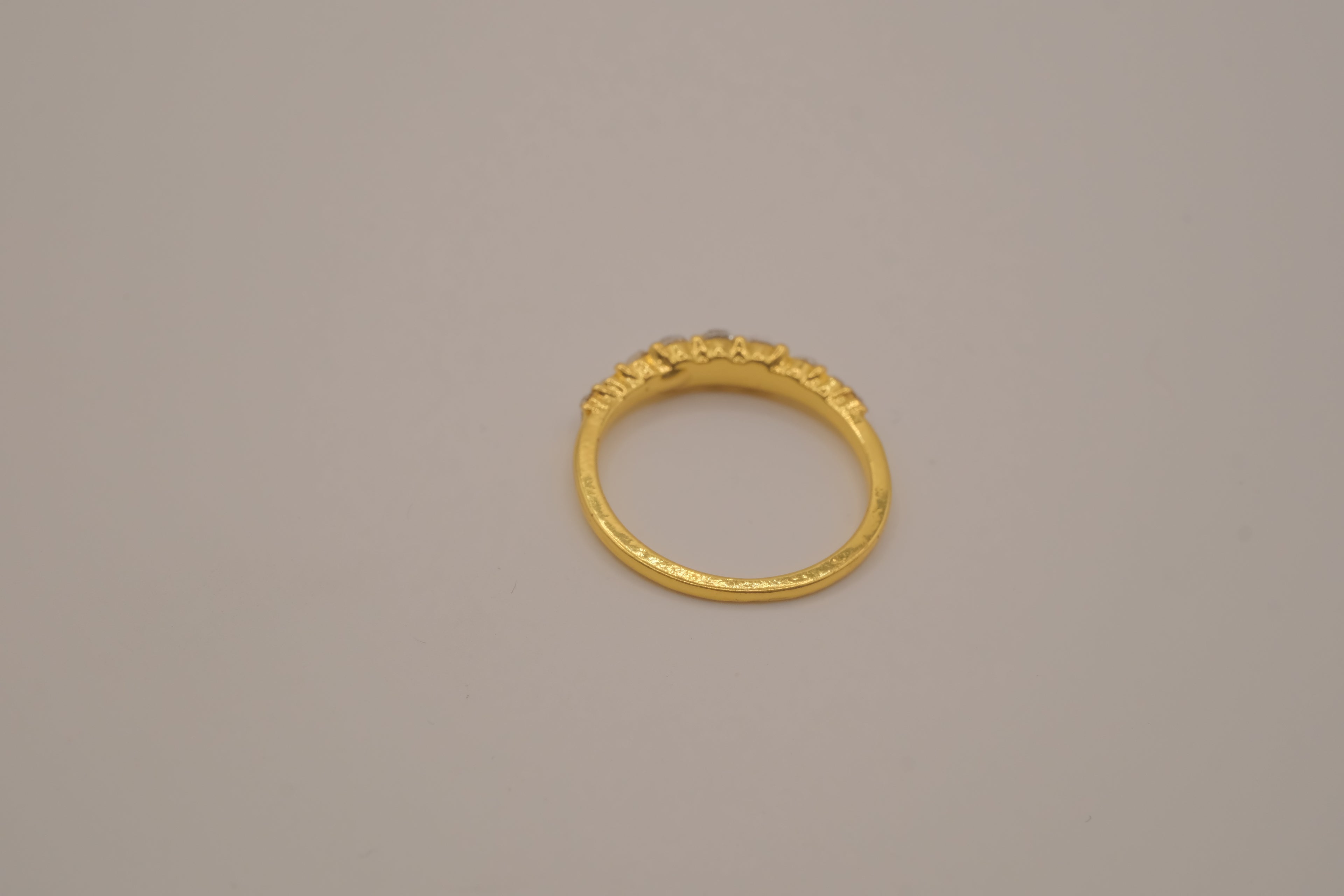 Gold tone prong-set oval clear stones ring