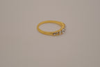 Gold tone prong-set oval clear stones ring