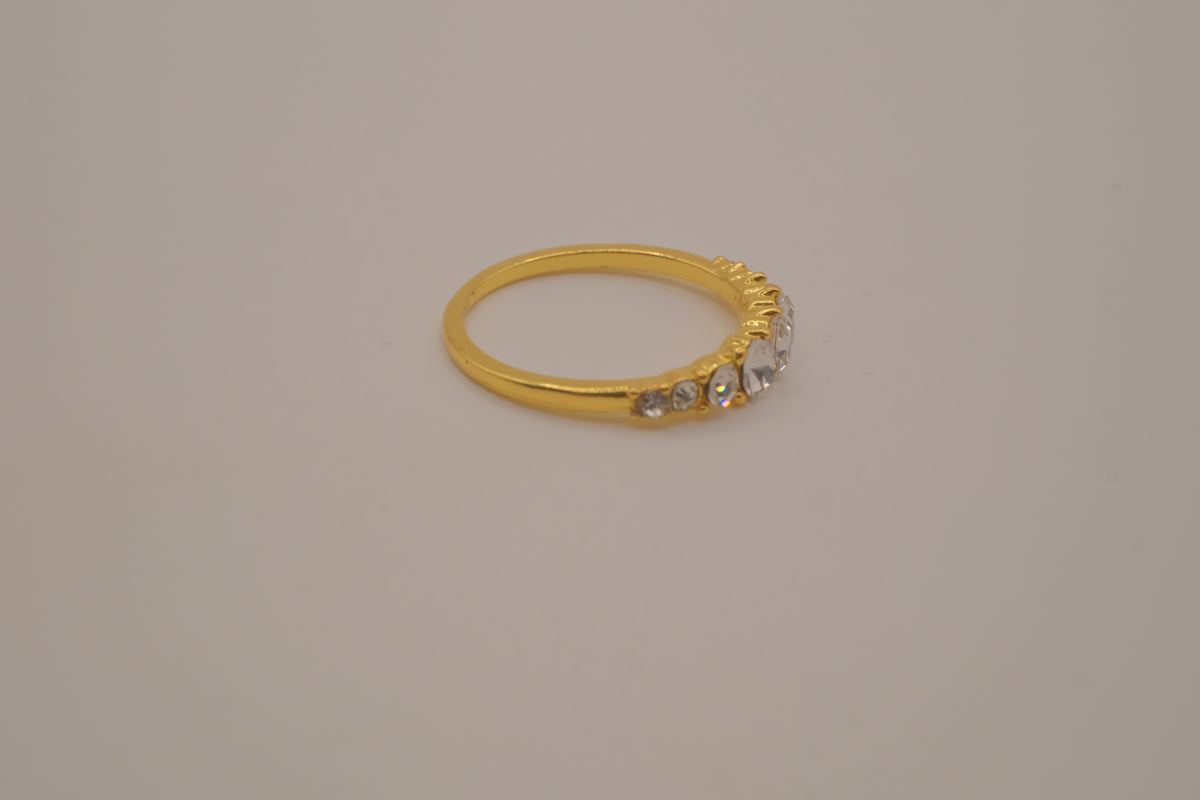 Gold tone prong-set oval clear stones ring