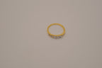 Gold tone prong-set oval clear stones ring