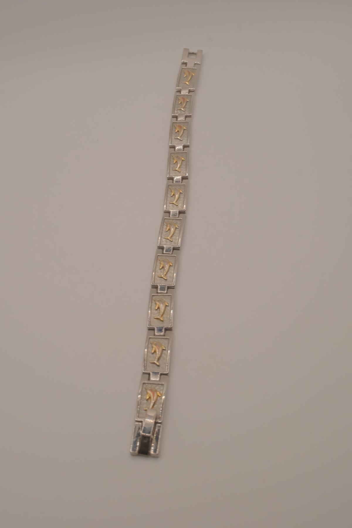 Two-tone dolphin design link bracelet