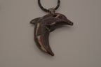 Hand-carved wooden dolphin pendant necklace