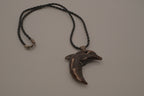 Hand-carved wooden dolphin pendant necklace