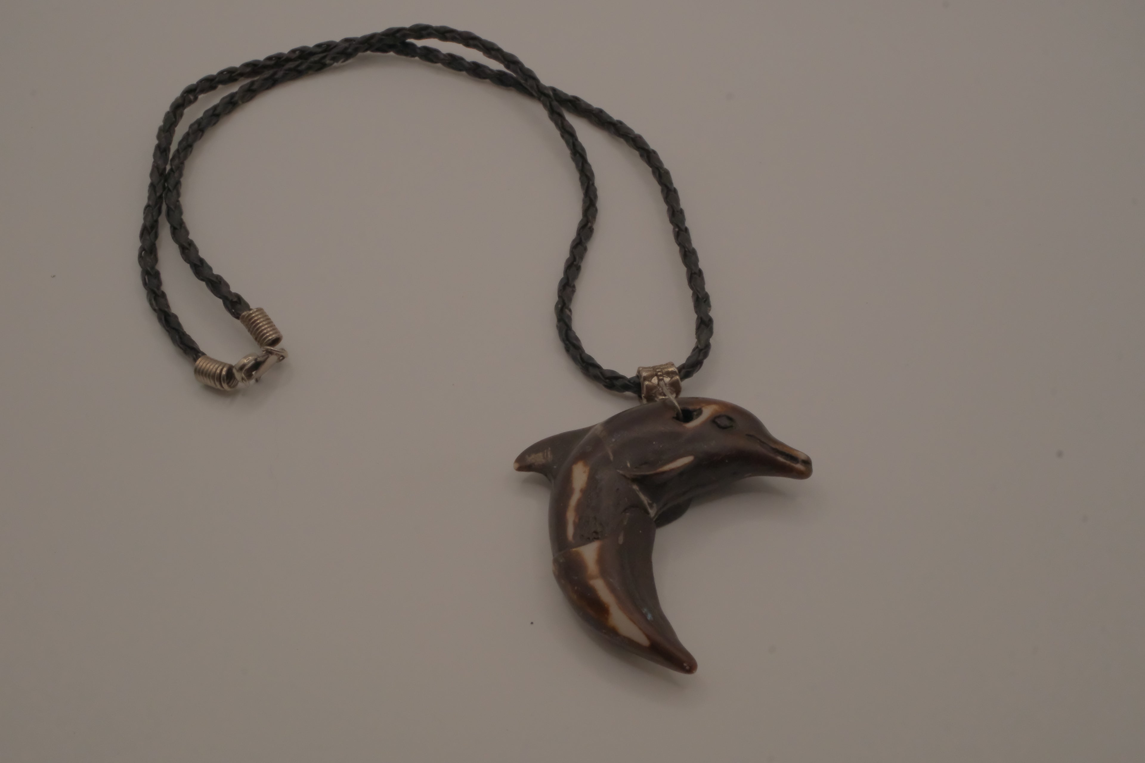 Hand-carved wooden dolphin pendant necklace