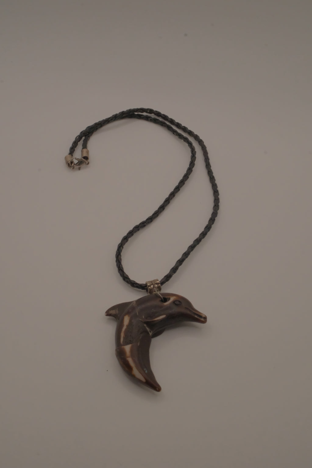 Hand-carved wooden dolphin pendant necklace