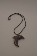 Hand-carved wooden dolphin pendant necklace
