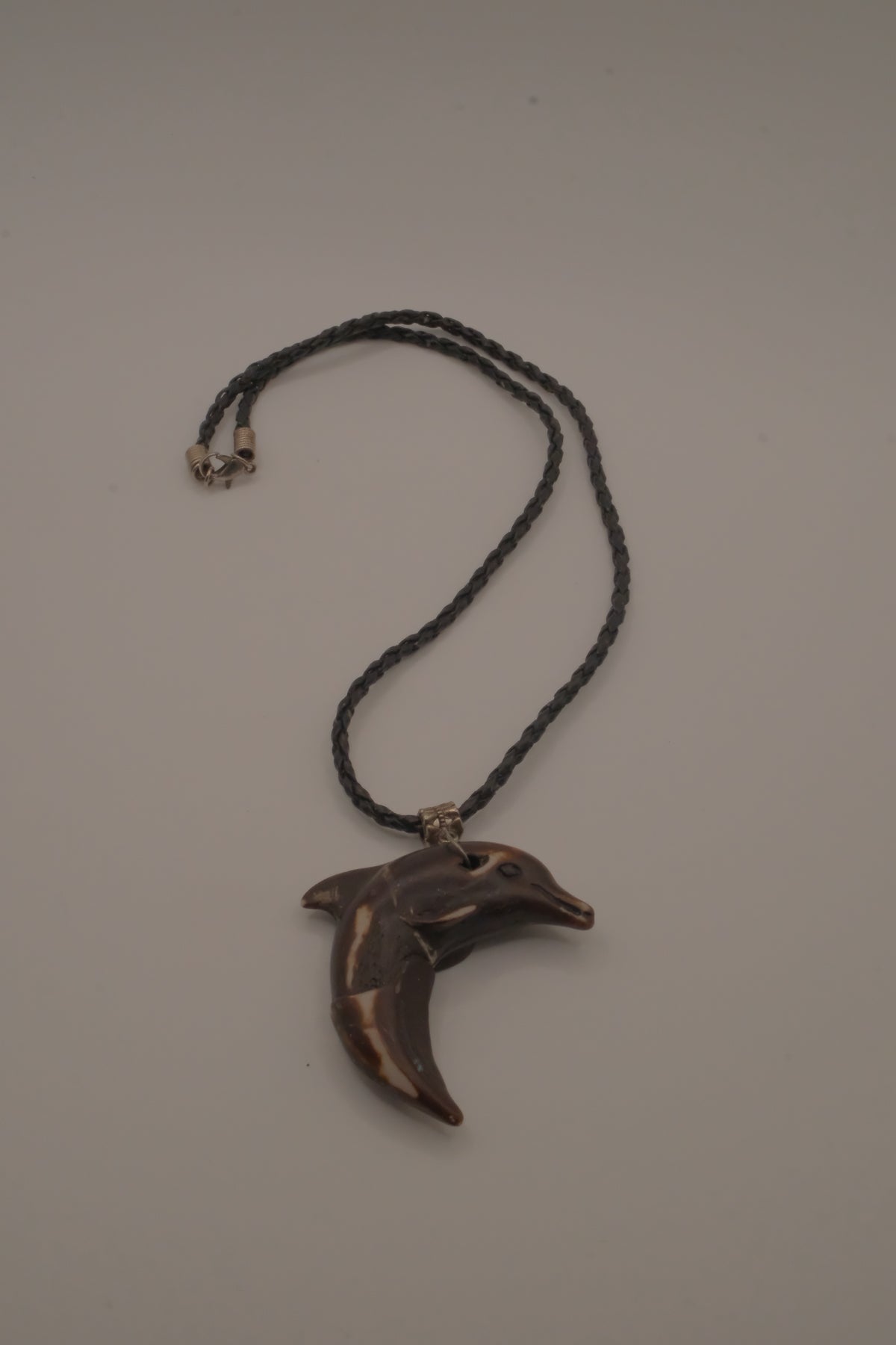 Hand-carved wooden dolphin pendant necklace