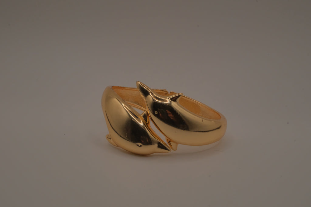 Gold tone two interlocking dolphins cuff bracelet