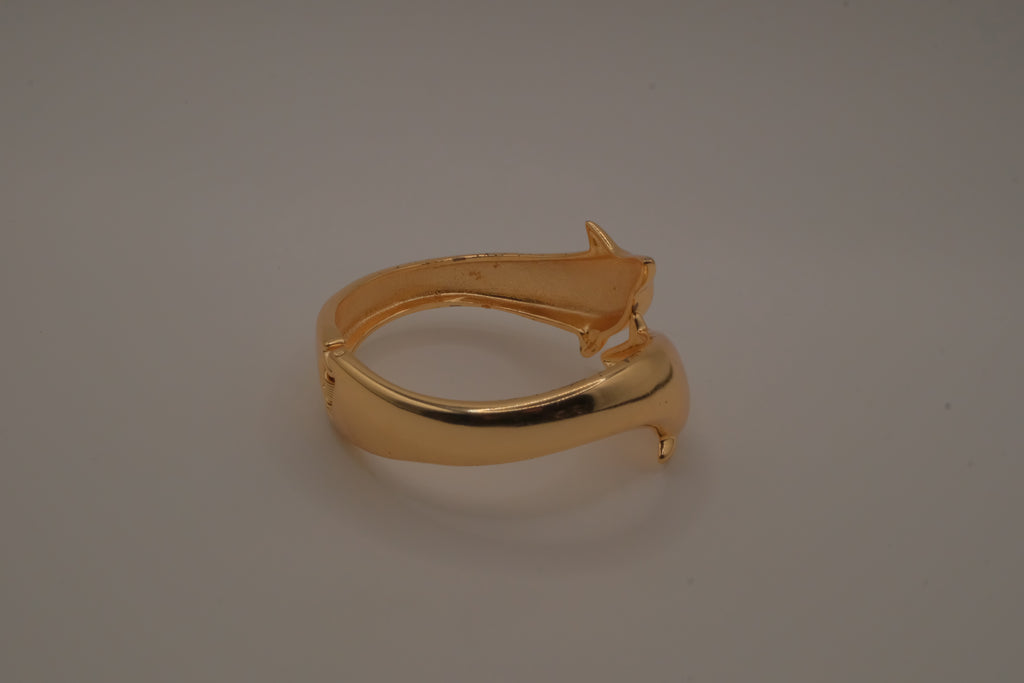 Gold tone two interlocking dolphins cuff bracelet