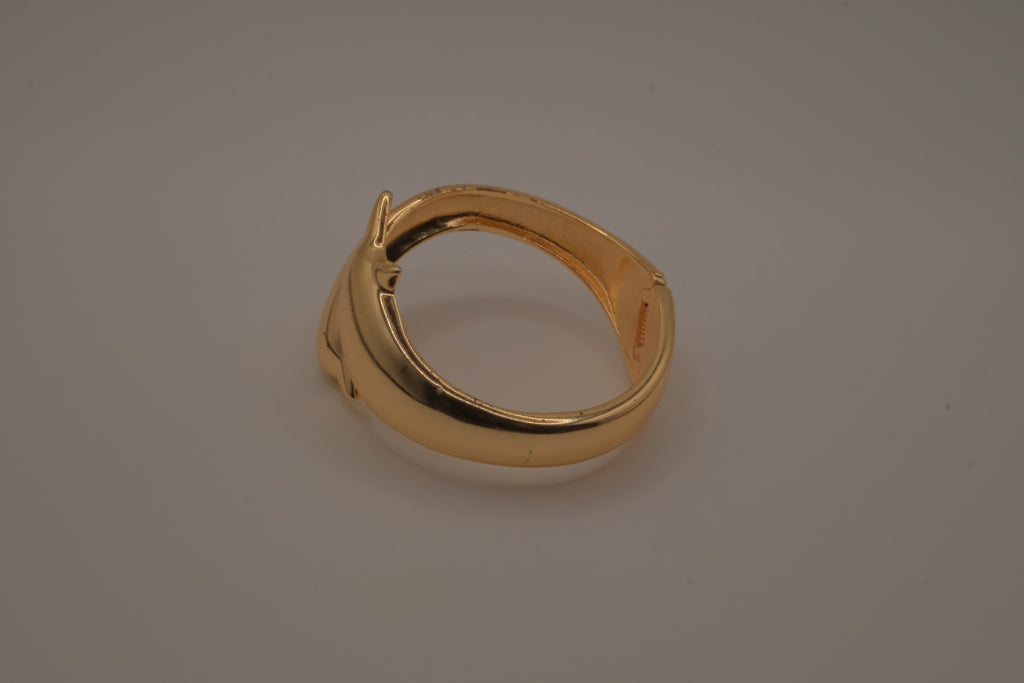 Gold tone two interlocking dolphins cuff bracelet