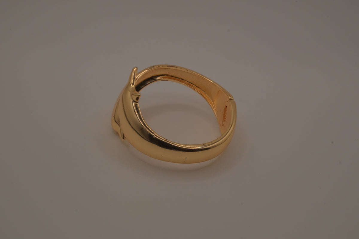 Gold tone two interlocking dolphins cuff bracelet