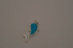 Dolphin pendant inlaid with a blue cabochon