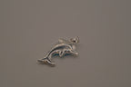 Dolphin pendant inlaid with a blue cabochon