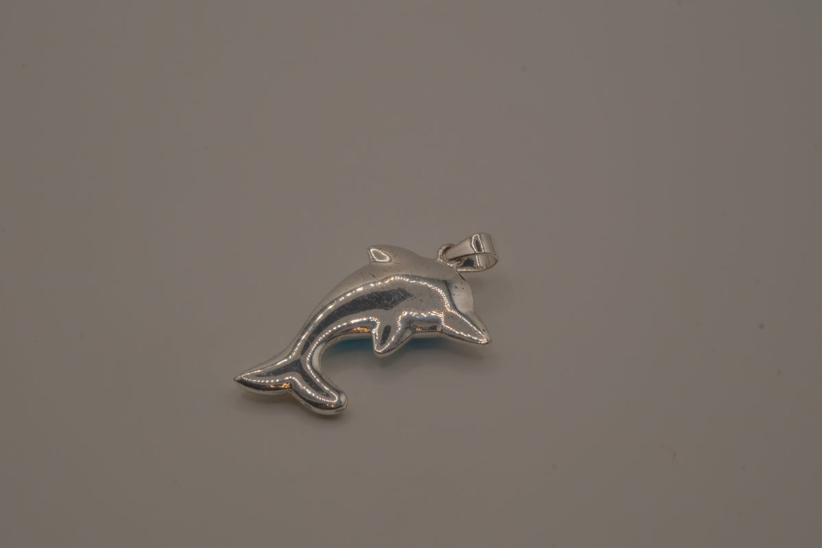 Dolphin pendant inlaid with a blue cabochon