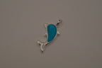 Dolphin pendant inlaid with a blue cabochon