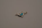 Dolphin pendant inlaid with vibrant blue stone