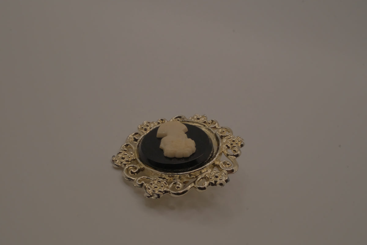 Vintage black and white cameo brooch