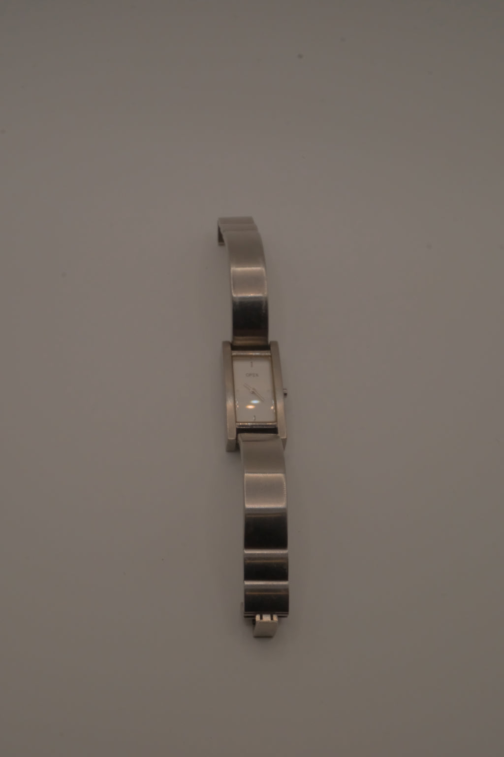 OPEX Paris minimalist rectangular stainless steel bangle watch