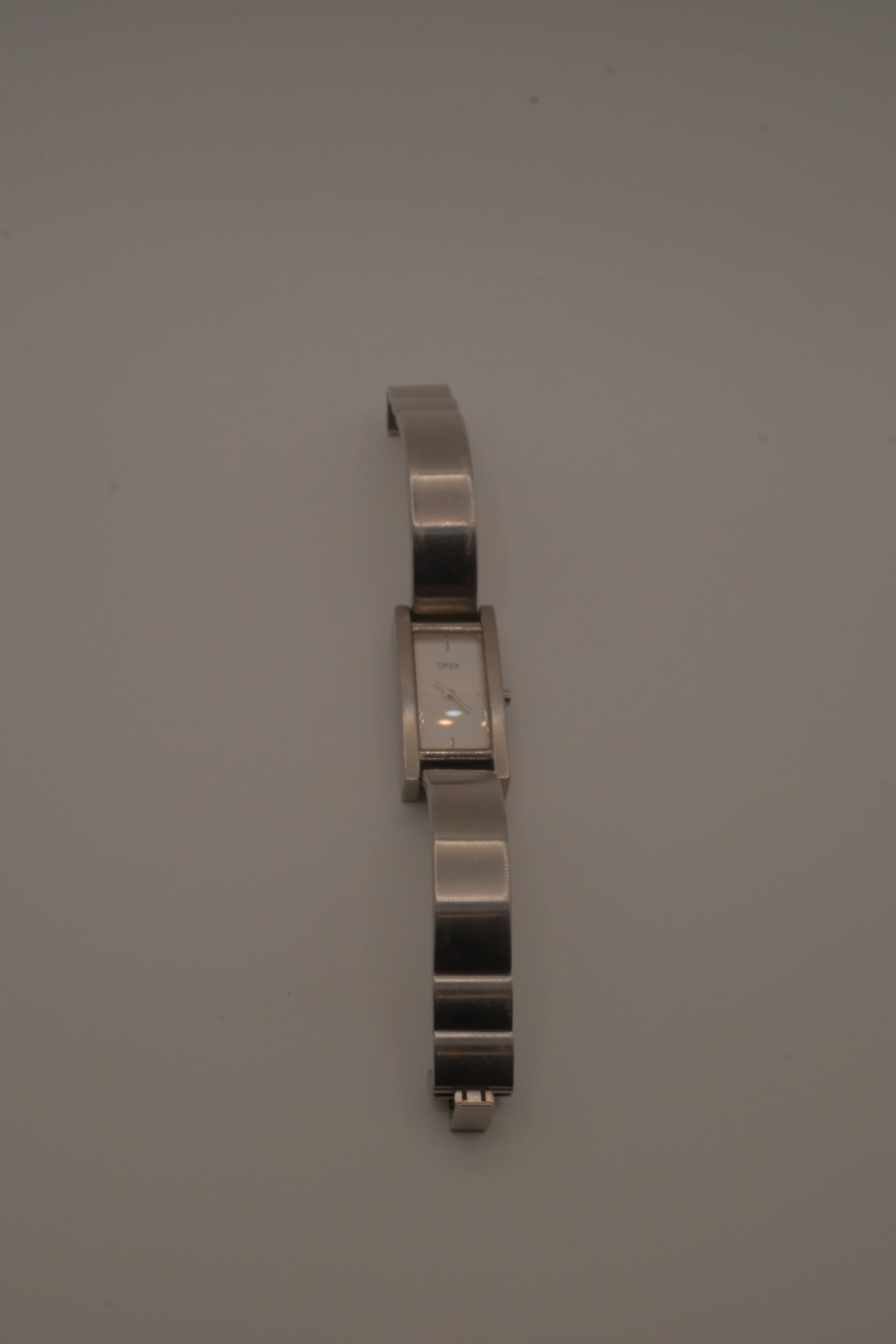 OPEX Paris minimalist rectangular stainless steel bangle watch