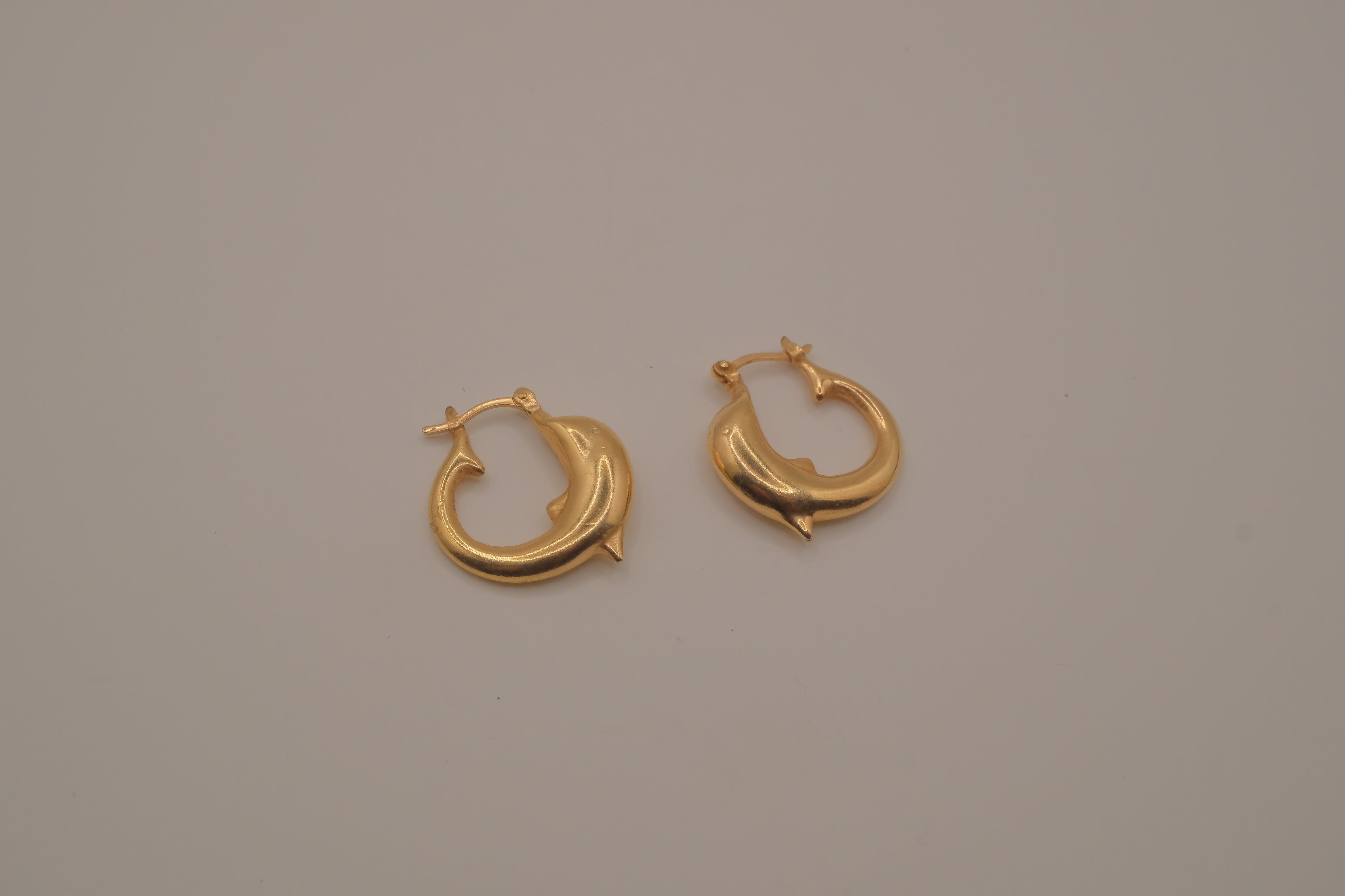 Gold dolphin hoop earring