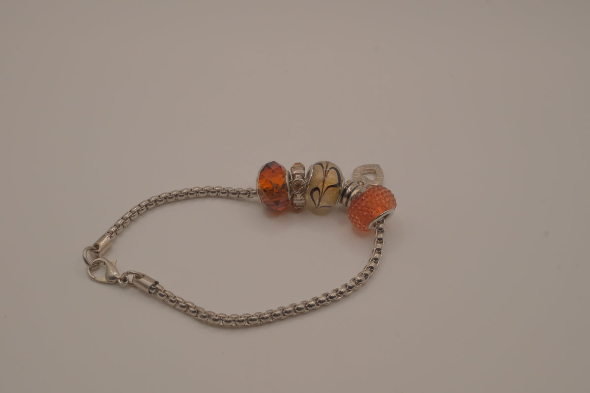 November themed silver snake-chain charm bracelet