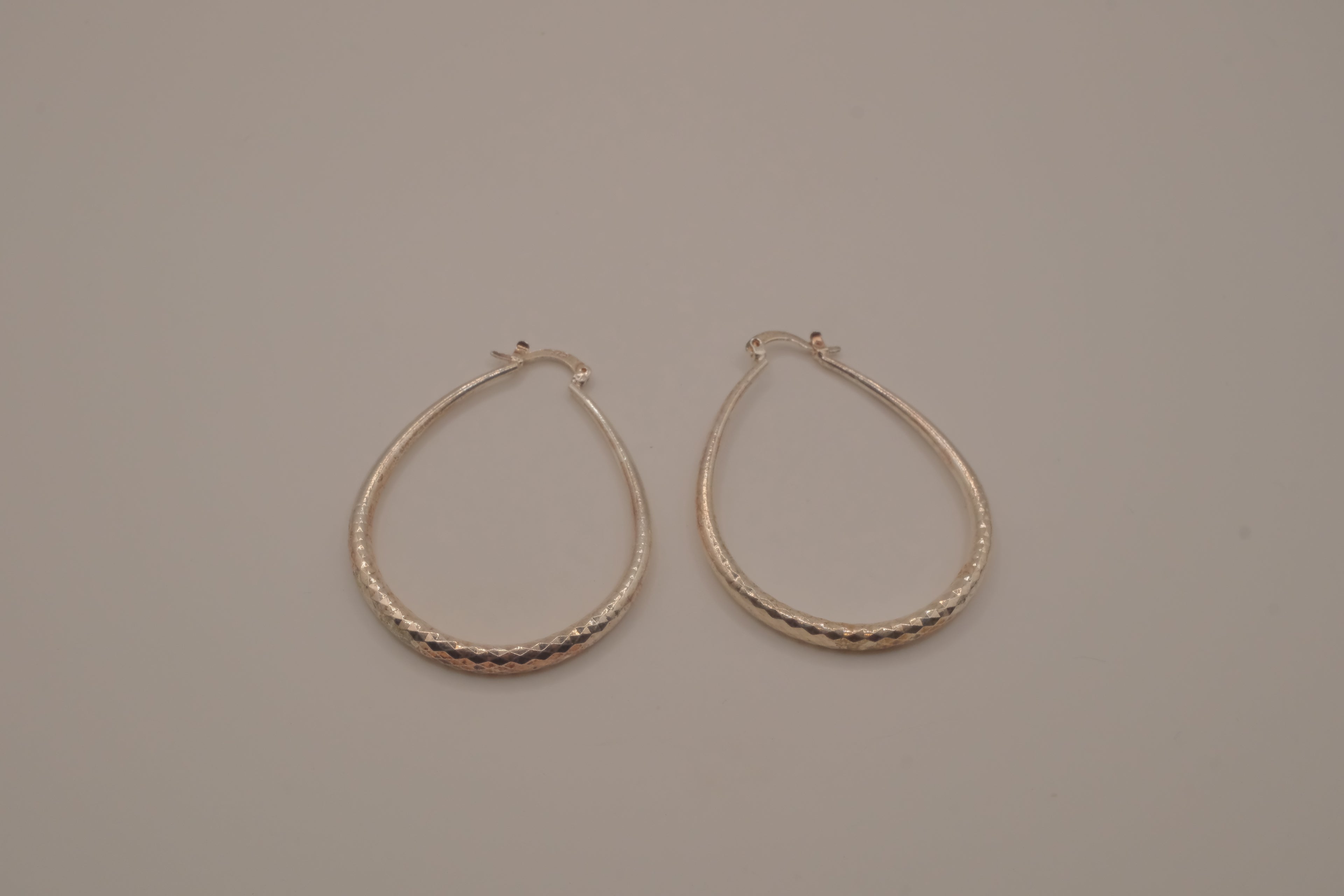Sterling silver teardrop-shaped hoop earrings