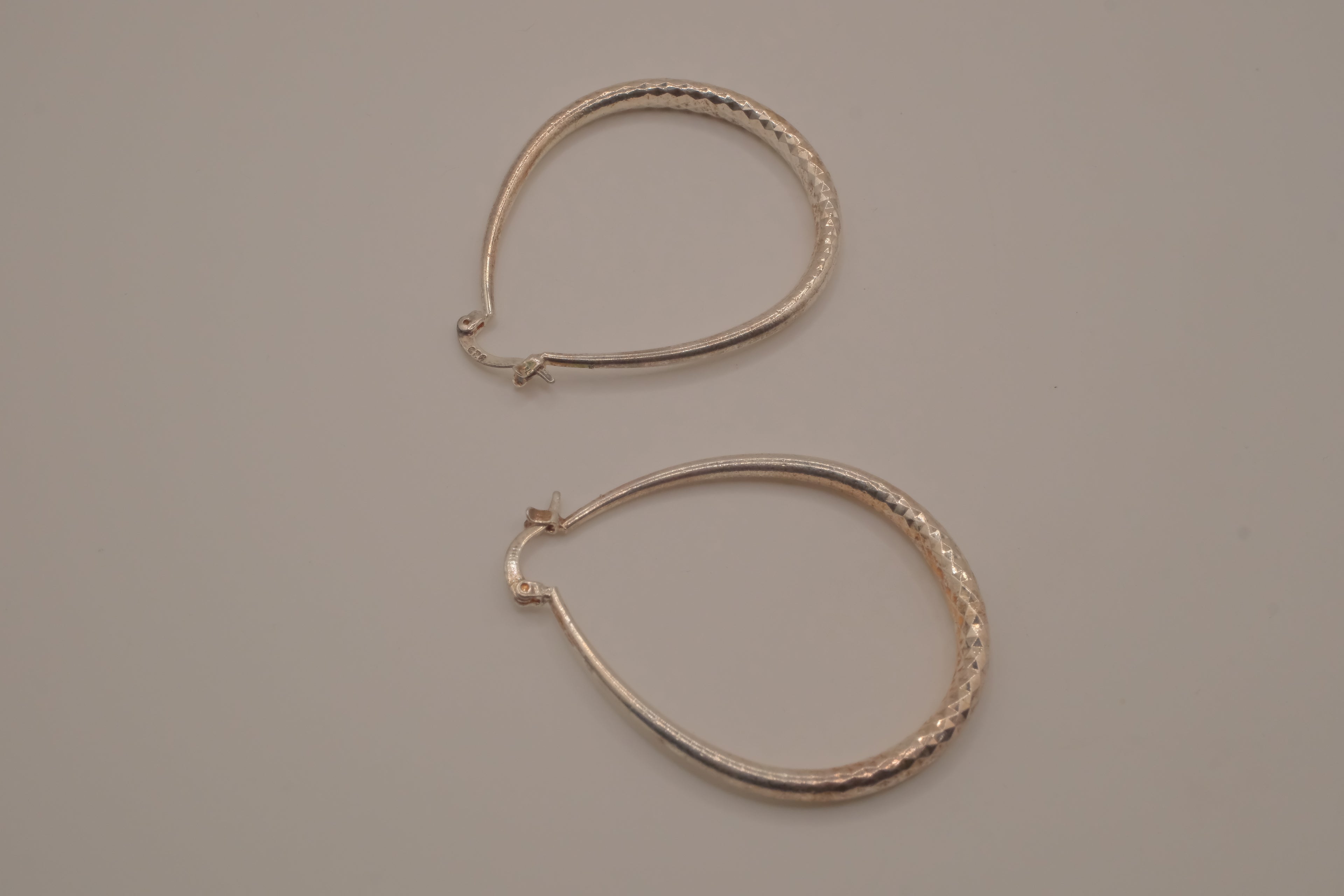 Sterling silver teardrop-shaped hoop earrings