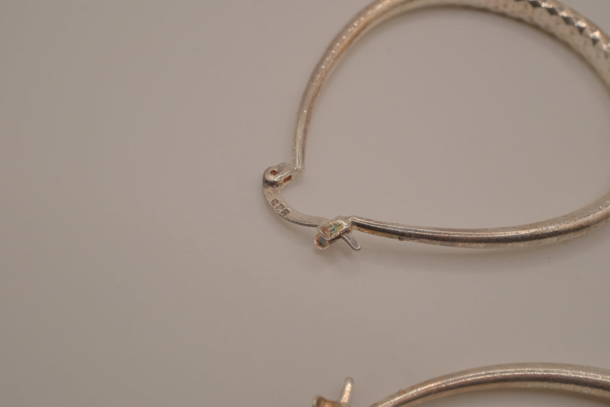 Sterling silver teardrop-shaped hoop earrings