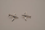Silver-toned jet airplane-shaped earrings