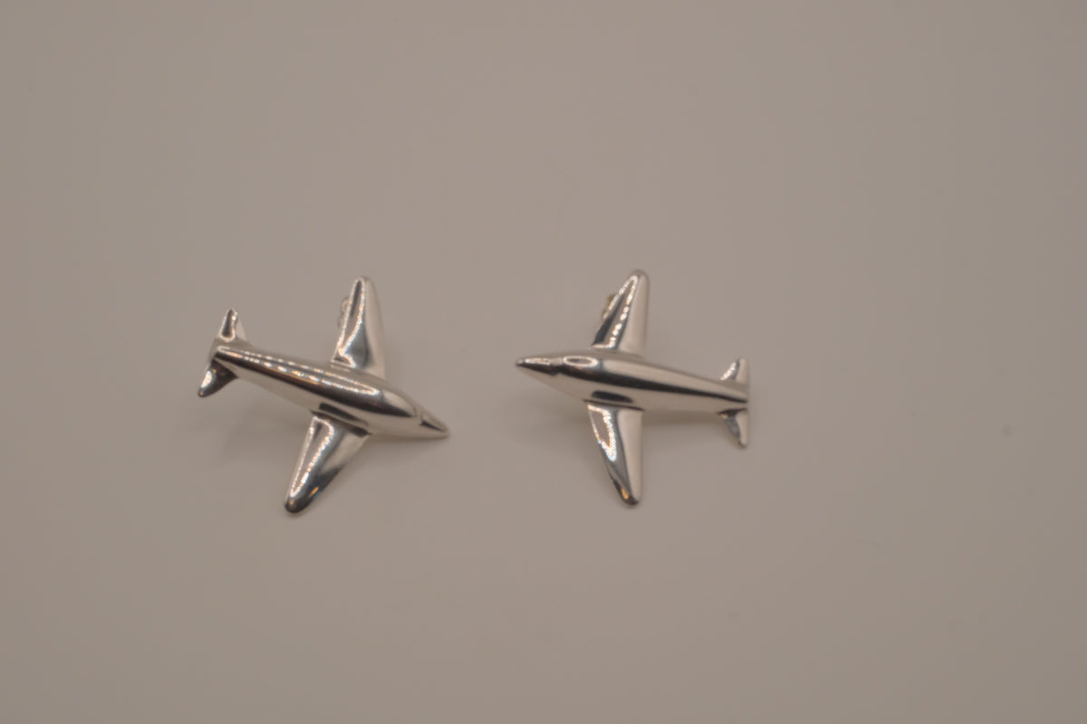 Silver-toned jet airplane-shaped earrings