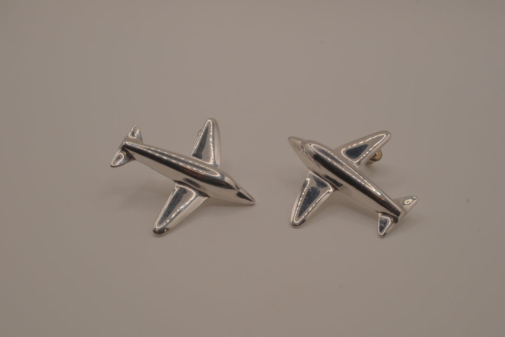 Silver-toned jet airplane-shaped earrings