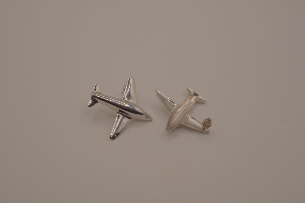 Silver-toned jet airplane-shaped earrings