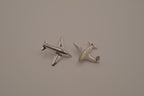 Silver-toned jet airplane-shaped earrings