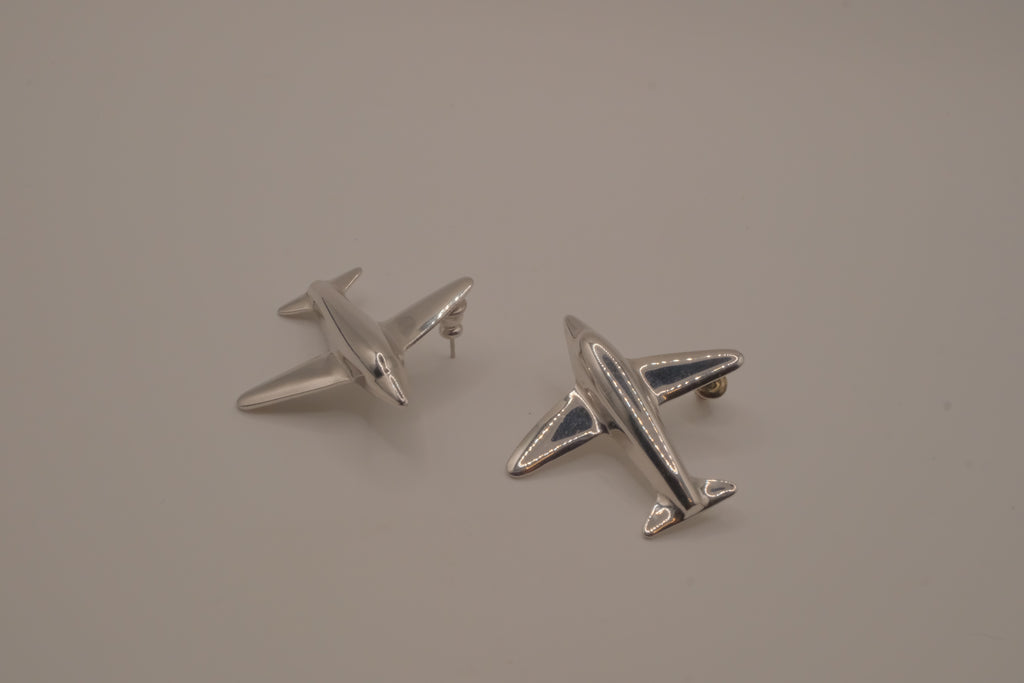 Silver-toned jet airplane-shaped earrings