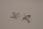 Silver-toned jet airplane-shaped earrings