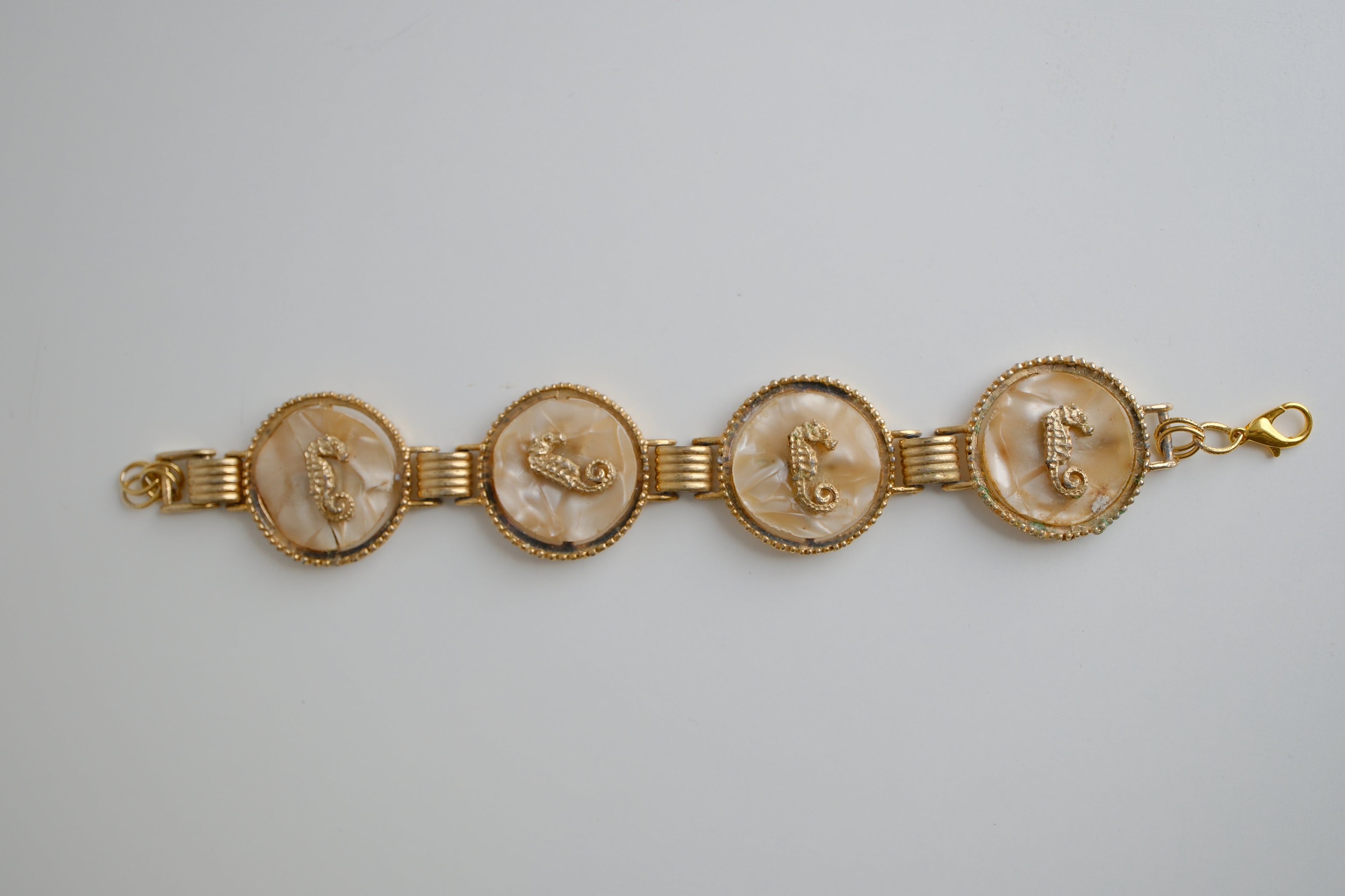 Vintage gold-tone link bracelet featuring seahorse motifs