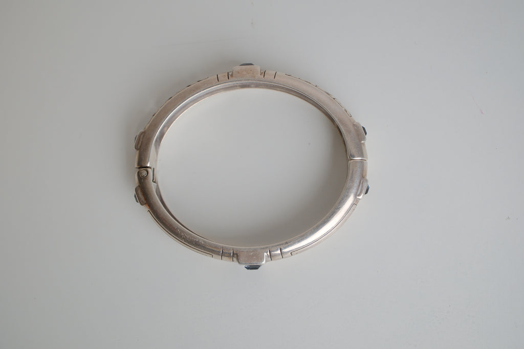 Silver toned patterned bangle with square grey stones